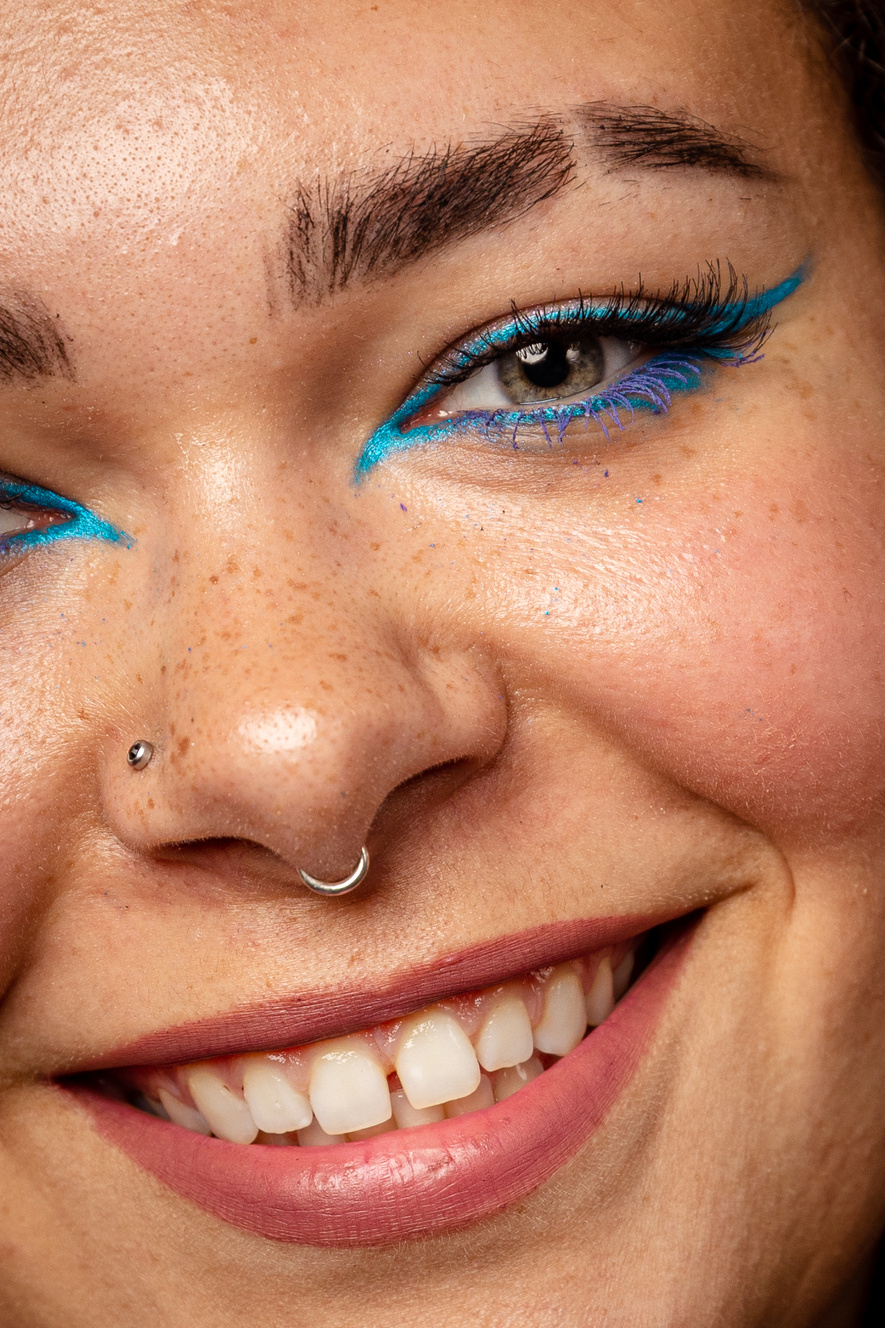 Closeup Portrait of a Smiling Woman with Blue Eyeliner